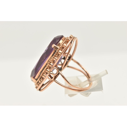 420 - A ROSE METAL SYNTHETIC COLOUR CHANGE SAPPHIRE RING, of an oval form, set with a large oval cut synth... 