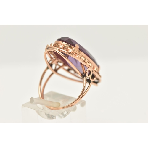 420 - A ROSE METAL SYNTHETIC COLOUR CHANGE SAPPHIRE RING, of an oval form, set with a large oval cut synth... 