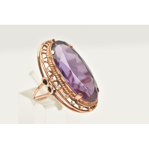 420 - A ROSE METAL SYNTHETIC COLOUR CHANGE SAPPHIRE RING, of an oval form, set with a large oval cut synth... 