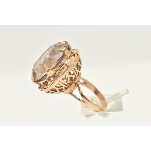 421 - A 9CT GOLD LARGE SMOKY QUARTZ DRESS RING, set with a circular cut smoky quartz, approximate diameter... 