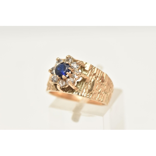 425 - A 9CT GOLD SAPPHIRE AND SPINEL CLUSTER RING, flower shape cluster set with a central circular cut bl... 