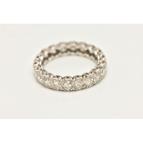 447 - A DIAMOND FULL ETERNITY BAND RING, twenty round brilliant cut diamonds prong set in white metal, app... 