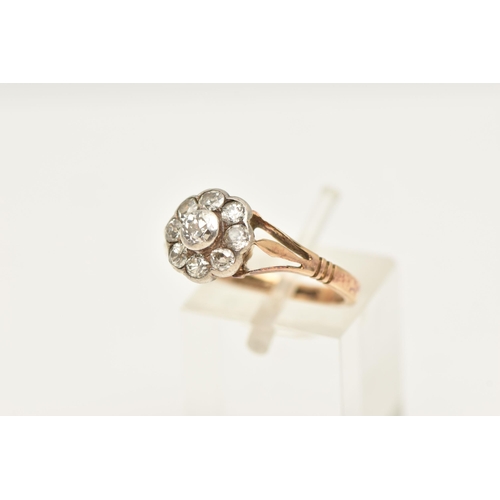 450 - AN EARLY 20TH CENTURY DIAMOND FLORAL CLUSTER RING, nine old cut diamonds, bezel set in a white metal... 