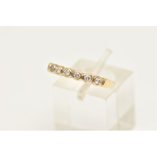 451 - A MODERN DIAMOND BAND RING, seven round brilliant cut diamonds bezel set in yellow gold, approximate... 