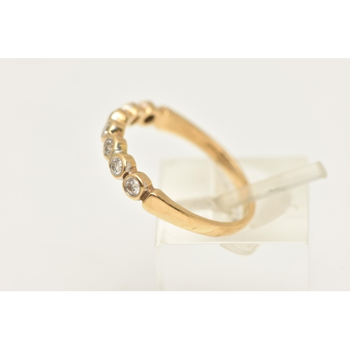 451 - A MODERN DIAMOND BAND RING, seven round brilliant cut diamonds bezel set in yellow gold, approximate... 