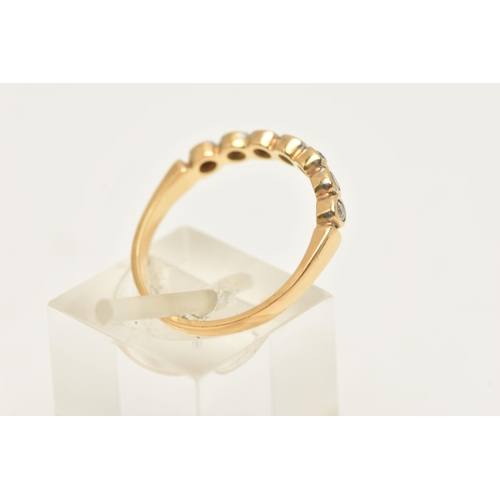 451 - A MODERN DIAMOND BAND RING, seven round brilliant cut diamonds bezel set in yellow gold, approximate... 