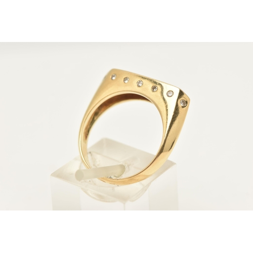 453 - A YELLOW METAL GEM SET SIGNET RING, a rectangular form signet ring, channel set to the top with seve... 