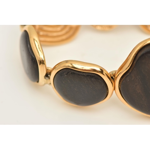 458 - A 'YVES SAINT LAURENT' BRACELET, designed as abstract wooden panels with gold plated surround and go... 