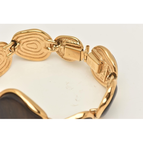 458 - A 'YVES SAINT LAURENT' BRACELET, designed as abstract wooden panels with gold plated surround and go... 