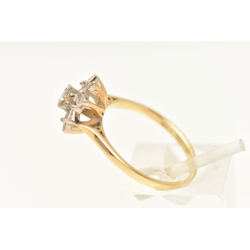 463 - A YELLOW METAL DIAMOND CLUSTER RING, set with a central round brilliant cut diamond, within a surrou... 