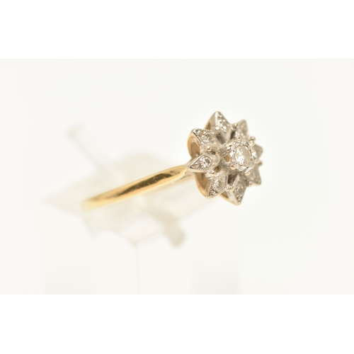 463 - A YELLOW METAL DIAMOND CLUSTER RING, set with a central round brilliant cut diamond, within a surrou... 