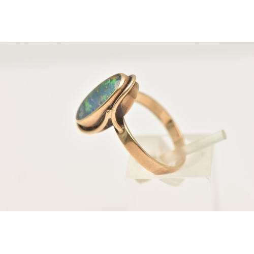 465 - A YELLOW METAL OPAL DOUBLET RING, of an oval form, set with an opal doublet cabochon, collet set wit... 