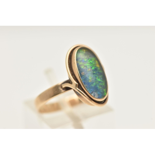 465 - A YELLOW METAL OPAL DOUBLET RING, of an oval form, set with an opal doublet cabochon, collet set wit... 