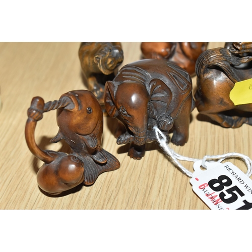 851 - A GROUP OF EIGHT WOODEN MODERN NETSUKE FIGURINES to include an octopus, a horse, a curled mouse, a p... 