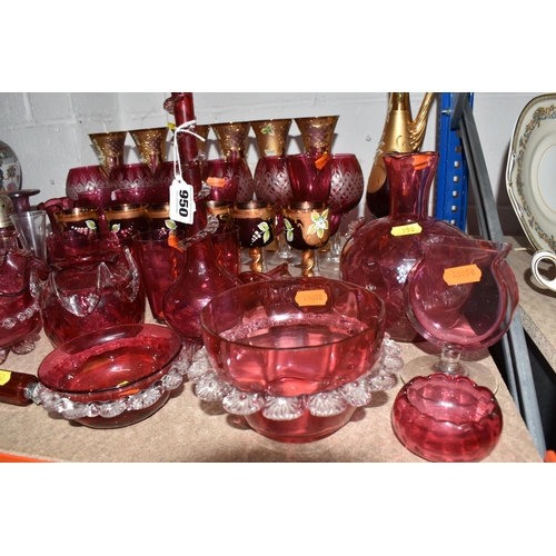 950 - A LARGE QUANTITY OF CRANBERRY GLASSWARE, to include, cranberry and gilt bohemian decanter, six champ... 