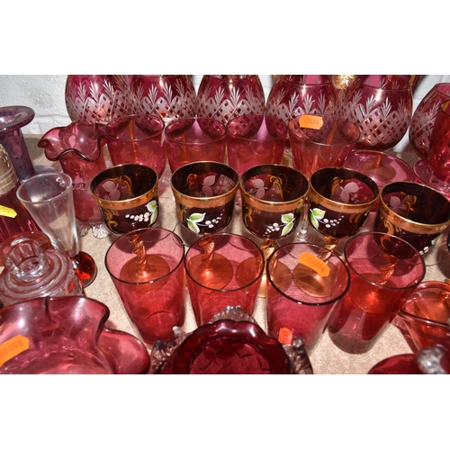 950 - A LARGE QUANTITY OF CRANBERRY GLASSWARE, to include, cranberry and gilt bohemian decanter, six champ... 