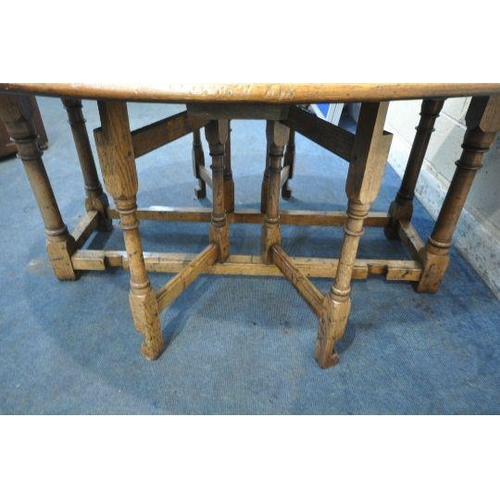 150 - AN 18TH CENTURY STYLE OAK WAKE TABLE, raised on block and turned legs, open width 143cm x closed wid... 