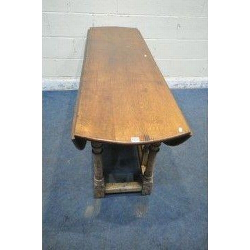 150 - AN 18TH CENTURY STYLE OAK WAKE TABLE, raised on block and turned legs, open width 143cm x closed wid... 