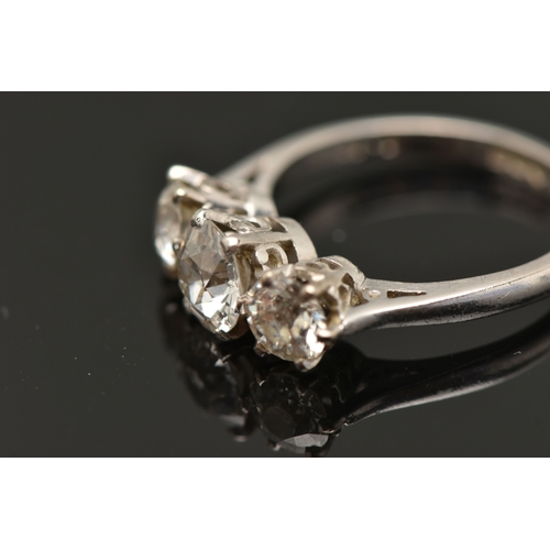 413 - A PLATINUM THREE STONE DIAMOND RING, three old cut diamonds, each claw set, central stone measuring ... 