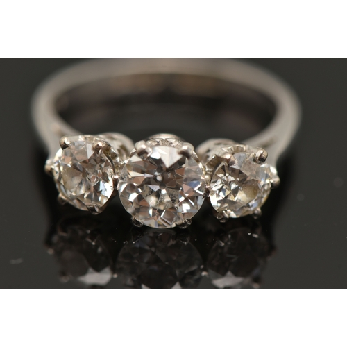 413 - A PLATINUM THREE STONE DIAMOND RING, three old cut diamonds, each claw set, central stone measuring ... 