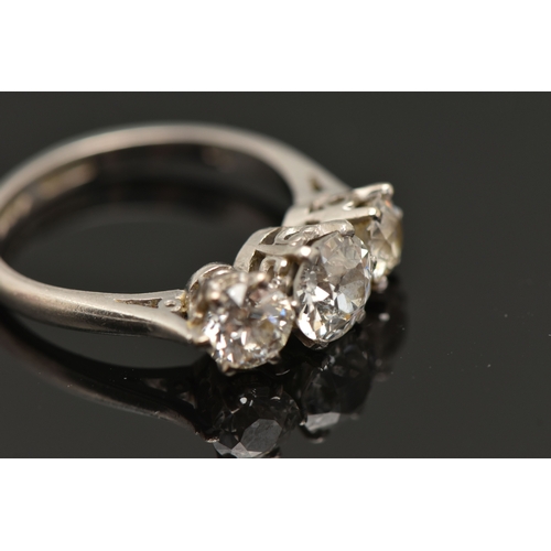 413 - A PLATINUM THREE STONE DIAMOND RING, three old cut diamonds, each claw set, central stone measuring ... 