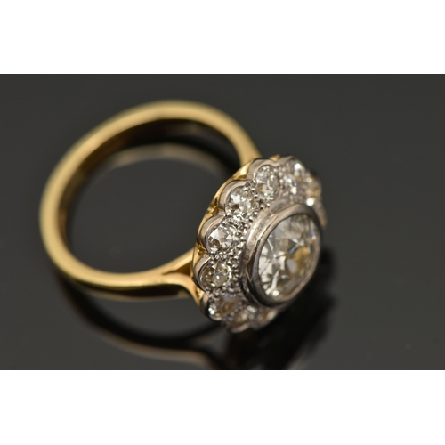 414 - AN 18CT GOLD DIAMOND CLUSTER RING, collet set with a central old cut diamond, spreads approximately ... 