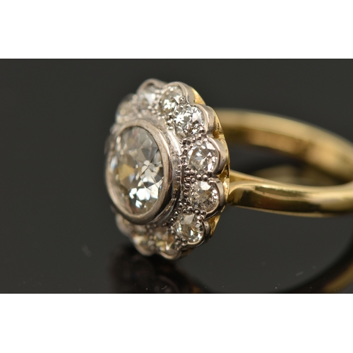 414 - AN 18CT GOLD DIAMOND CLUSTER RING, collet set with a central old cut diamond, spreads approximately ... 