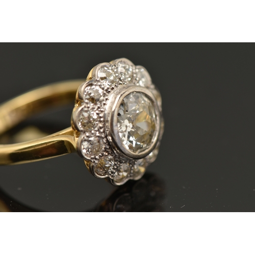 414 - AN 18CT GOLD DIAMOND CLUSTER RING, collet set with a central old cut diamond, spreads approximately ... 