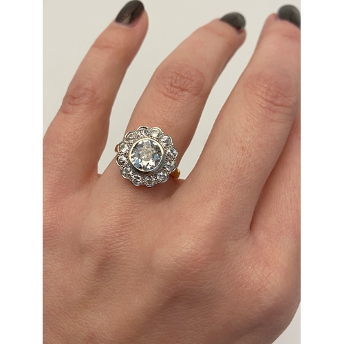 414 - AN 18CT GOLD DIAMOND CLUSTER RING, collet set with a central old cut diamond, spreads approximately ... 