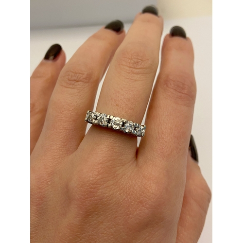 411 - A WHITE METAL FIVE STONE DIAMOND RING, designed as a row of five slightly graduating old cut diamond... 