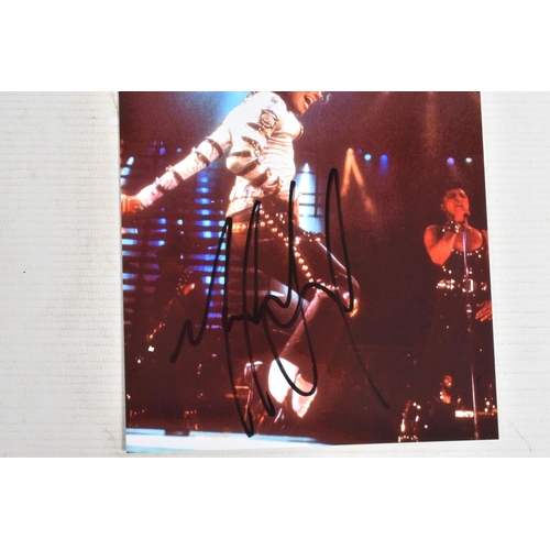 197 - A SIGNED 6   X 8   PHOTOGRAPH OF MICHAEL JACKSON ON STAGE, signed in black marker and in its plastic... 