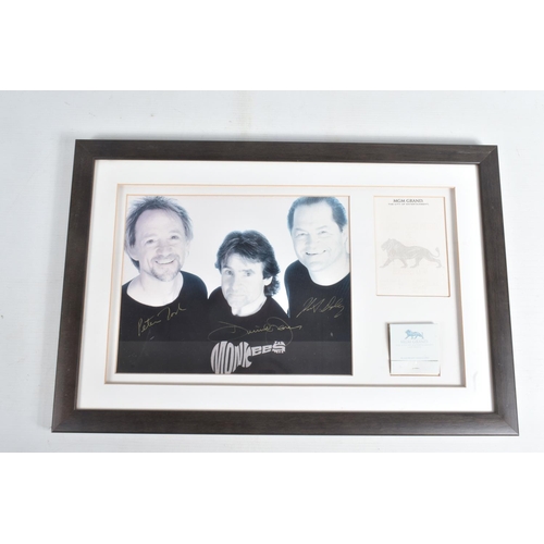 205 - TWO FRAMED SIGNED PHOTOGRAPHS OF BAND GROUPS, to include a black and white photograph of The Monkees... 