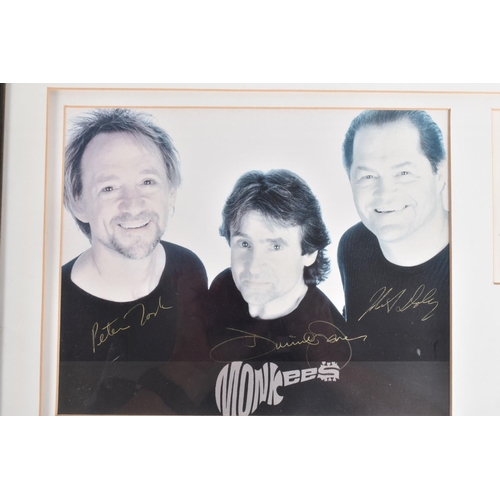 205 - TWO FRAMED SIGNED PHOTOGRAPHS OF BAND GROUPS, to include a black and white photograph of The Monkees... 