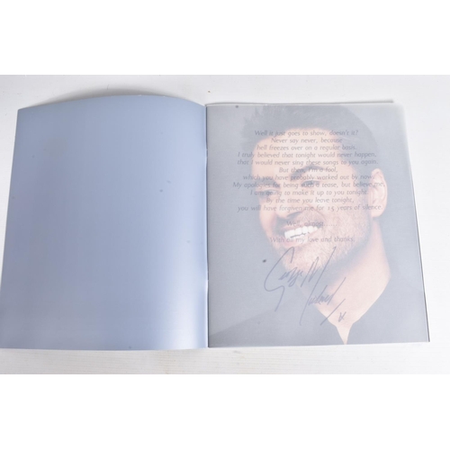 222 - A SIGNED 25LIVE GEORGE MICHAEL PROGRAMME, 35cm x 30cm, signed to the front blue panel