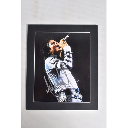 230 - TWO SIGNED PHOTOGRAPHS OF MICHAEL JACKSON, one is framed with a mat 12   x 10   signed in silver mar... 