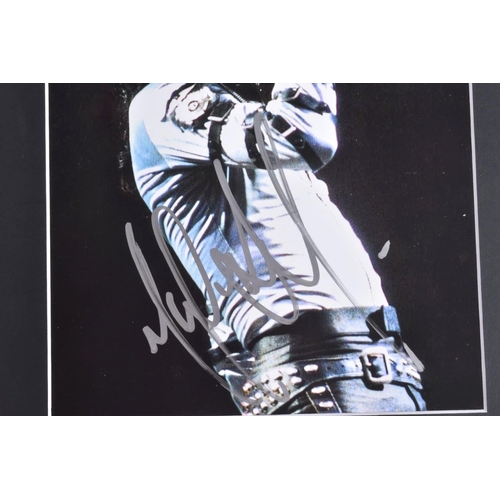 230 - TWO SIGNED PHOTOGRAPHS OF MICHAEL JACKSON, one is framed with a mat 12   x 10   signed in silver mar... 