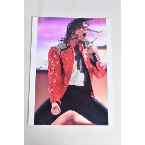 230 - TWO SIGNED PHOTOGRAPHS OF MICHAEL JACKSON, one is framed with a mat 12   x 10   signed in silver mar... 