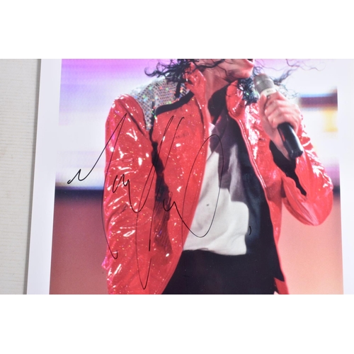 230 - TWO SIGNED PHOTOGRAPHS OF MICHAEL JACKSON, one is framed with a mat 12   x 10   signed in silver mar... 