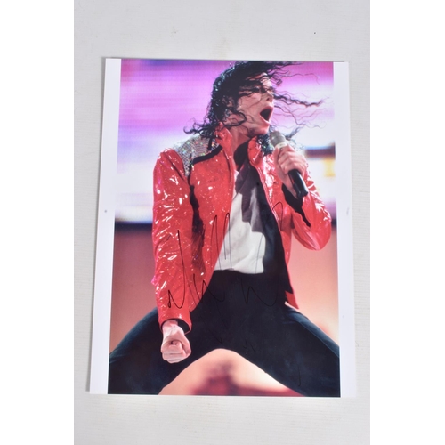 231 - TWO SIGNED PHOTOGRAPHS OF MICHAEL JACKSON, one is framed with a mat 12   x 10   signed in black mark... 