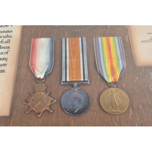 242 - A WWI FRAMED CASUALTY GROUP OF MEDALS, these include a 1914/15 Trio of medals, memorial plaque scrol... 