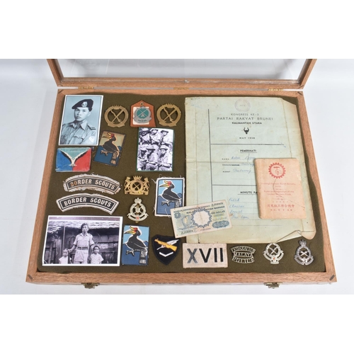 268 - LARGE WOOD AND GLAZED FRAME CONTAINING VARIOUS INSIGNIA, patches and metal badges photos etc all rel... 