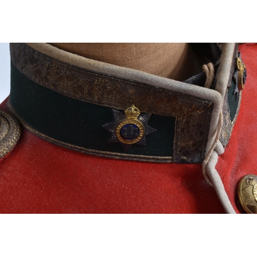 289 - A DEVONSHIRE REGIMENT RED MILITARY TUNIC, this has Devonshire buttons and collar badges and the insi... 