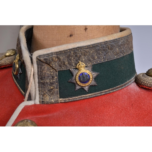 289 - A DEVONSHIRE REGIMENT RED MILITARY TUNIC, this has Devonshire buttons and collar badges and the insi... 