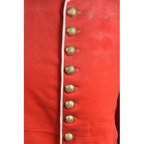 289 - A DEVONSHIRE REGIMENT RED MILITARY TUNIC, this has Devonshire buttons and collar badges and the insi... 