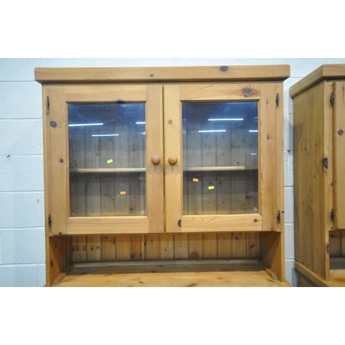 151 - TWO MODERN PINE DRESSERS, the top section with double glass doors, atop a base with two drawers, and... 