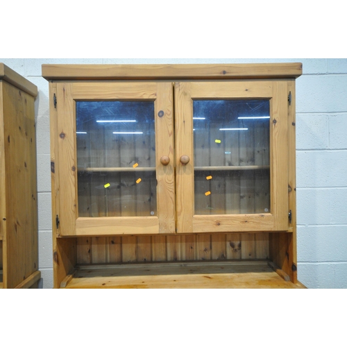 151 - TWO MODERN PINE DRESSERS, the top section with double glass doors, atop a base with two drawers, and... 