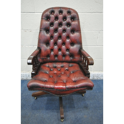 156 - AN OXBLOOD BUTTONED SWIVEL OFFICE CHAIR, with spindled armrests, on brass castors, width 60cm x dept... 