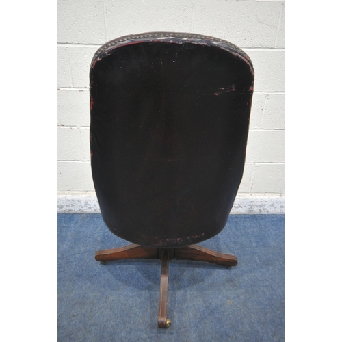 156 - AN OXBLOOD BUTTONED SWIVEL OFFICE CHAIR, with spindled armrests, on brass castors, width 60cm x dept... 