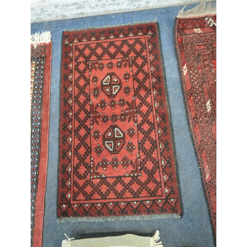 189 - A RED GROUND RECTANGULAR RUG, with sixteen medallions, surrounded by a multi-strap border, 142cm x 9... 