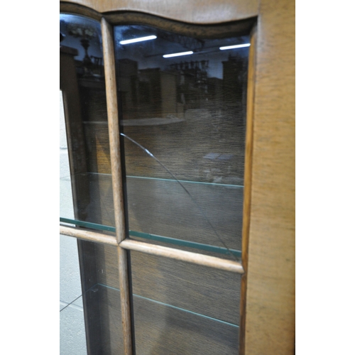 200 - A 20TH CENTURY WALNUT DISPLAY CABINET, the double glazed doors enclosing four glass shelves, raised ... 